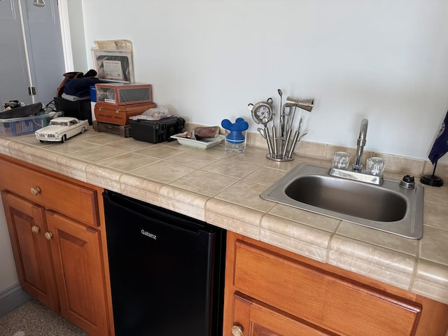 20444 Baldpate Ln, Onancock, VA 23417 - kitchen featuring dishwasher, brown cabinets, and tile countertops