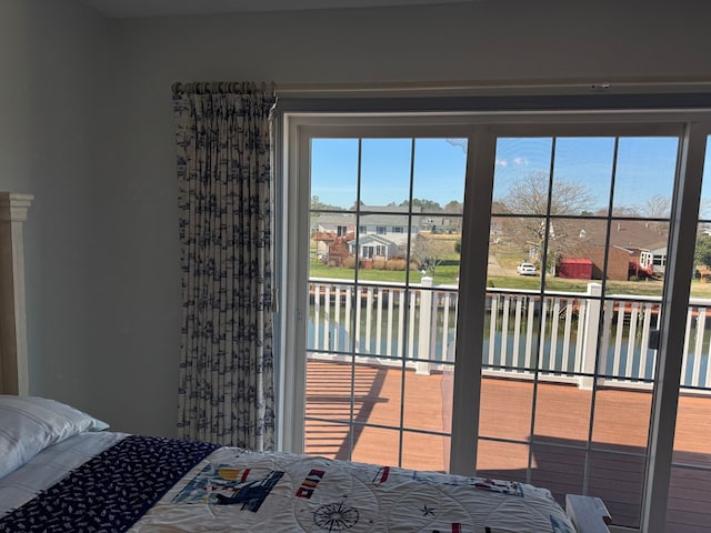20444 Baldpate Ln, Onancock, VA 23417 - bedroom with a water view, a residential view, multiple windows, and access to exterior