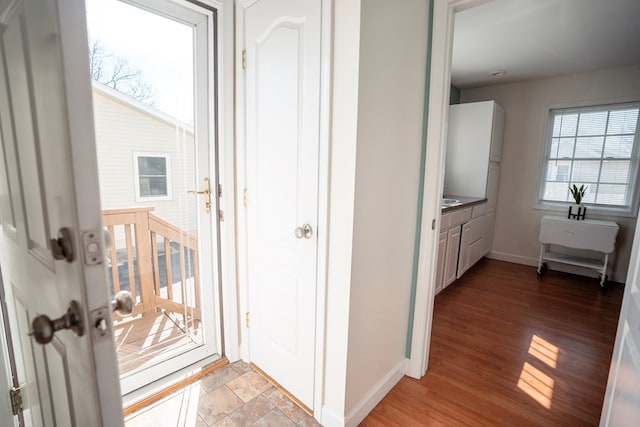 entryway featuring light wood-style flooring and baseboards