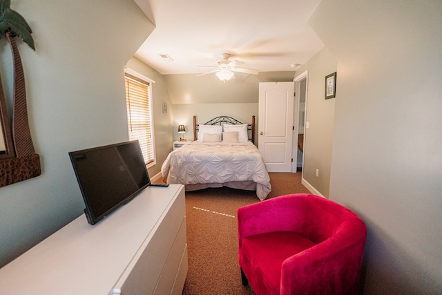 bedroom with a ceiling fan, carpet, visible vents, baseboards, and lofted ceiling