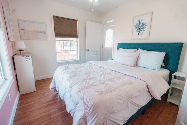 bedroom with baseboards and wood finished floors