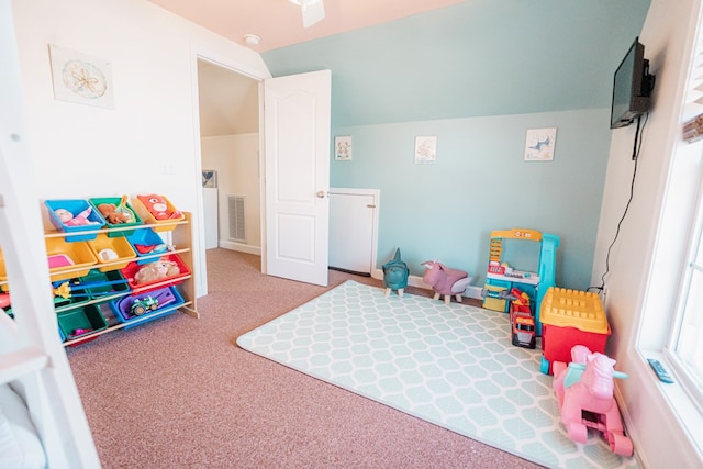 playroom featuring vaulted ceiling, carpet flooring, and visible vents