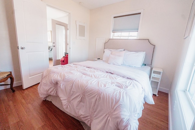 bedroom with light wood-style flooring and baseboards