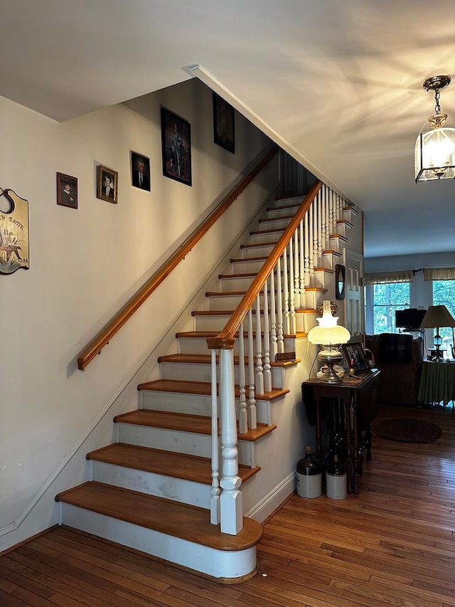 stairs featuring hardwood / wood-style floors