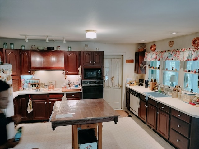 kitchen with dark brown cabinetry, sink, black appliances, and track lighting