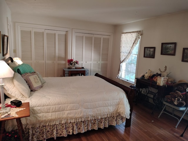 bedroom with multiple closets and hardwood / wood-style floors