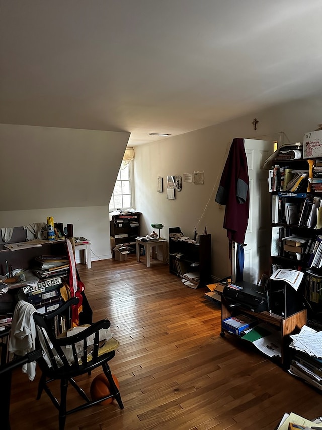 interior space featuring wood-type flooring and vaulted ceiling