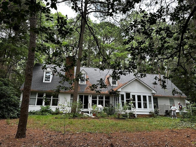 rear view of property with a sunroom