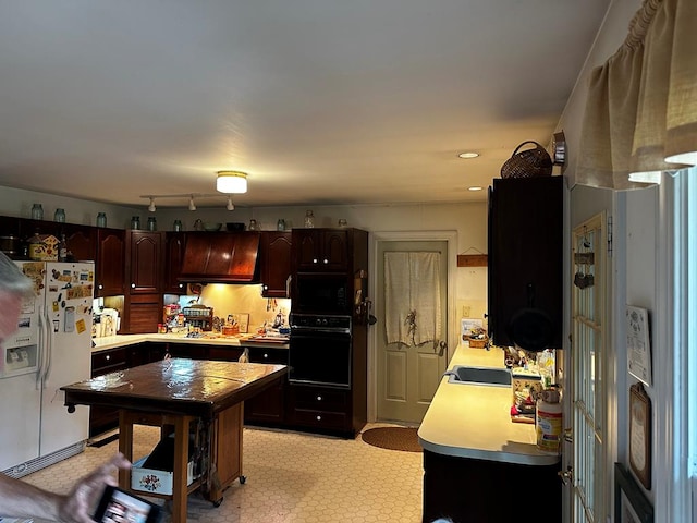 7086 Long Point Rd, Exmore, VA 23350 - kitchen featuring black appliances, light countertops, light floors, and dark brown cabinets