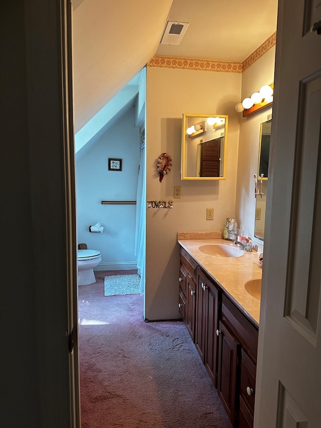 bathroom with a shower, vanity, and toilet