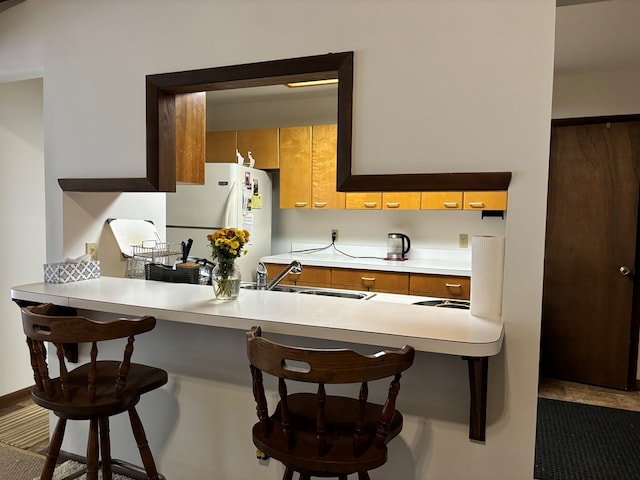 26491 Mason Rd, Bloxom, VA 23308 - kitchen with a kitchen bar, white fridge, and sink
