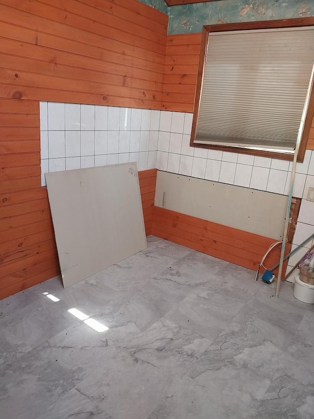 bathroom with concrete floors and wooden walls