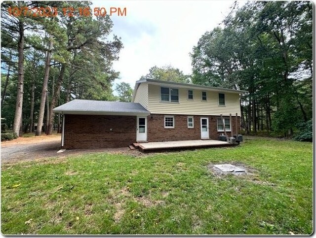 back of property featuring a yard and a patio