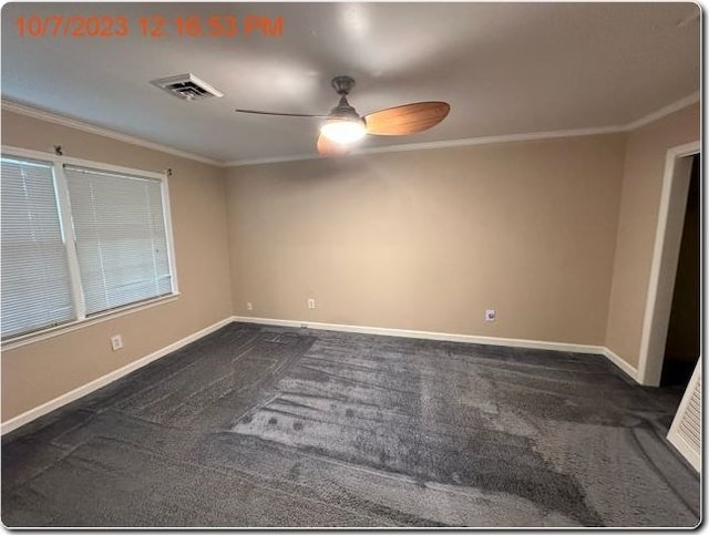 spare room with crown molding, ceiling fan, and dark carpet