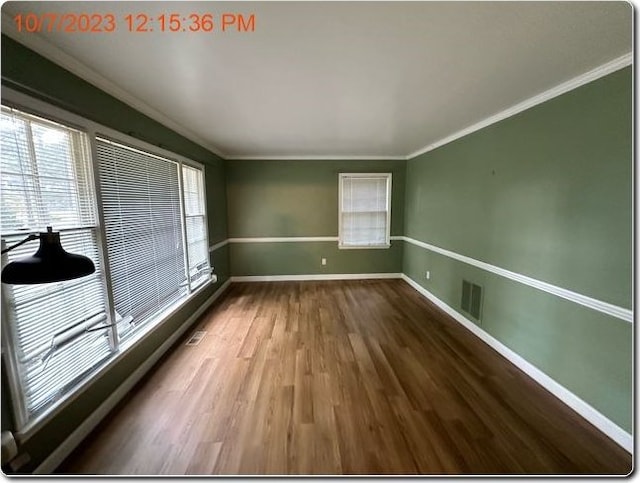 unfurnished room with wood-type flooring and crown molding