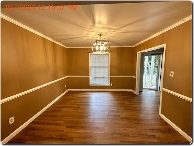 unfurnished room with wood-type flooring, ornamental molding, and a notable chandelier