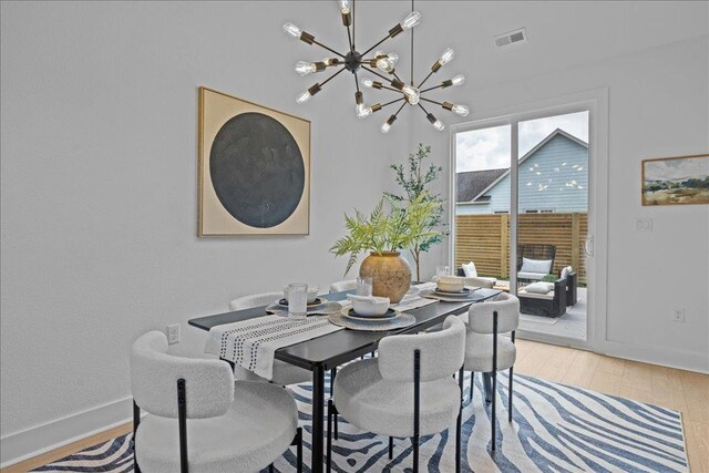 22231 Verlinda Lndg S, Cape Charles, VA 23310 - dining room featuring a chandelier, light wood-style floors, and baseboards