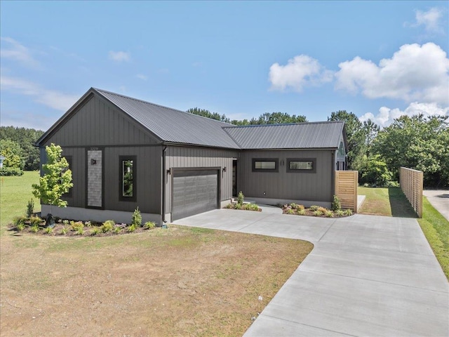 22231 Verlinda Lndg S, Cape Charles, VA 23310 - modern inspired farmhouse featuring concrete driveway, an attached garage, metal roof, and a front yard