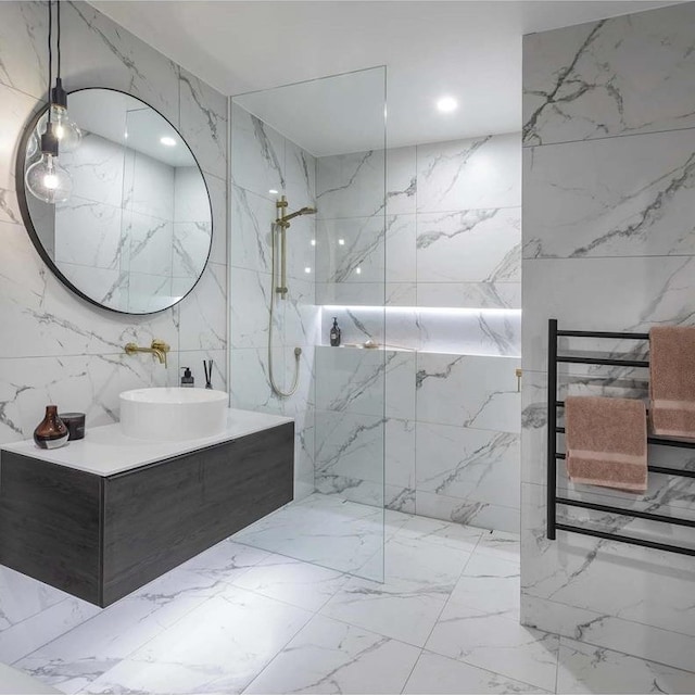 bathroom featuring vanity, tile walls, and a shower