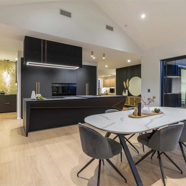 kitchen with lofted ceiling and oven