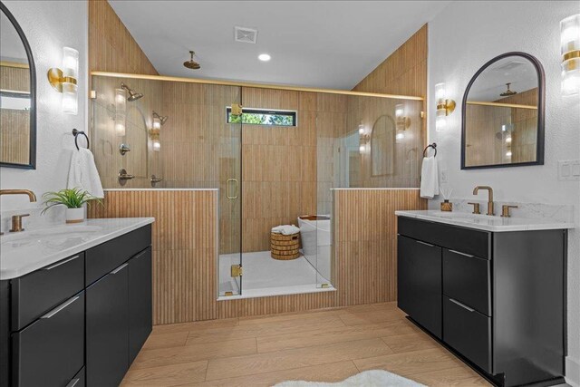 22231 Verlinda Lndg S, Cape Charles, VA 23310 - bathroom featuring a shower stall, two vanities, and wood finished floors
