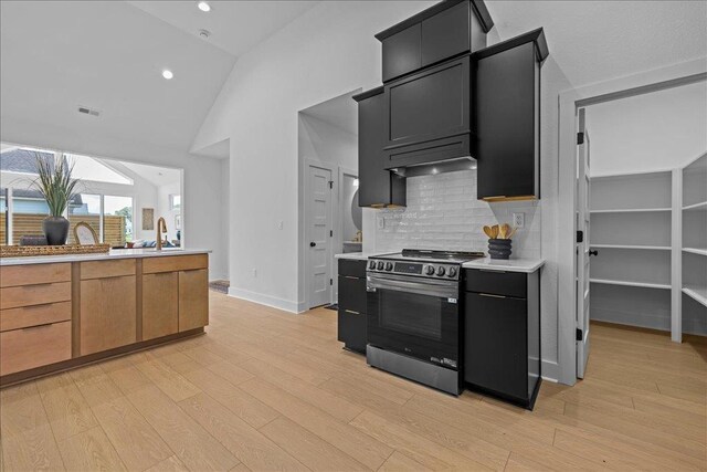 22231 Verlinda Lndg S, Cape Charles, VA 23310 - kitchen featuring electric range, light countertops, light wood finished floors, decorative backsplash, and recessed lighting