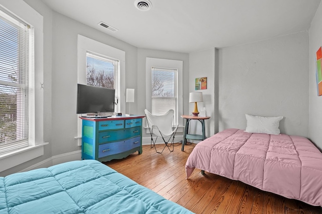 4282 Main St, Chincoteague, VA 23336 - bedroom featuring multiple windows and hardwood / wood-style flooring
