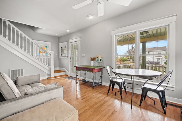 4282 Main St, Chincoteague, VA 23336 - dining room featuring stairway, light wood-style flooring, a ceiling fan, and recessed lighting