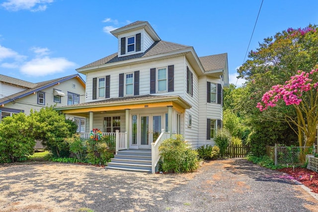 4282 Main St, Chincoteague, VA 23336 - view of front facade featuring covered porch and a shingled roof