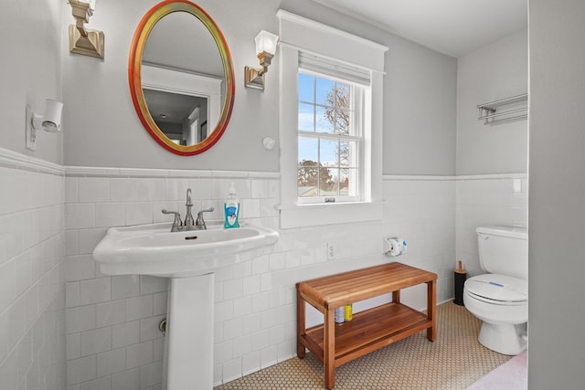 4282 Main St, Chincoteague, VA 23336 - half bath featuring tile walls, wainscoting, and tile patterned floors