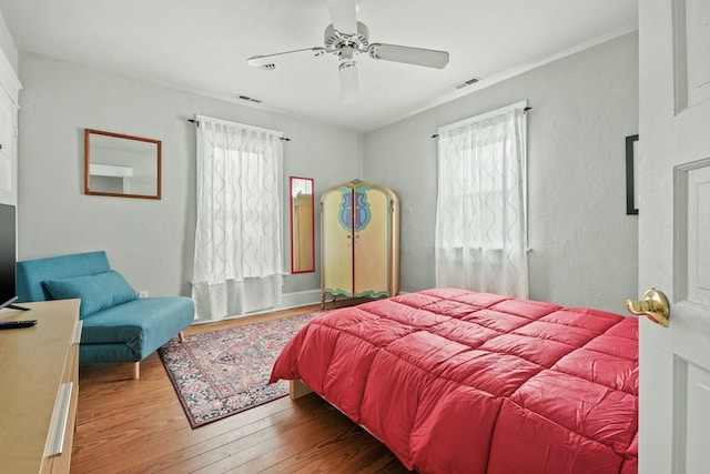4282 Main St, Chincoteague, VA 23336 - bedroom with multiple windows, wood finished floors, and ceiling fan