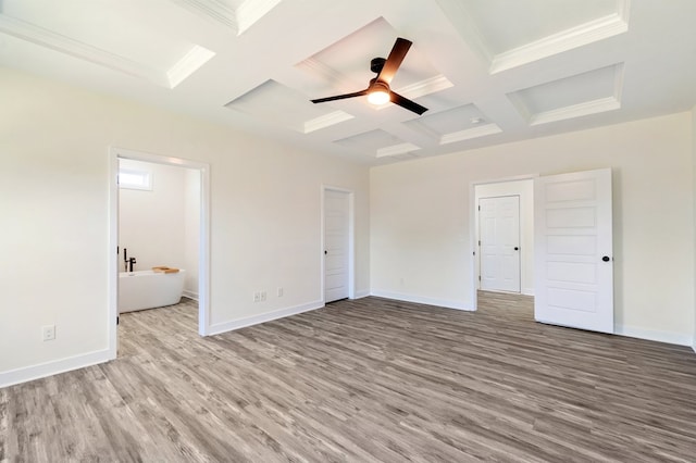 unfurnished bedroom featuring coffered ceiling, ceiling fan, connected bathroom, beamed ceiling, and light hardwood / wood-style floors