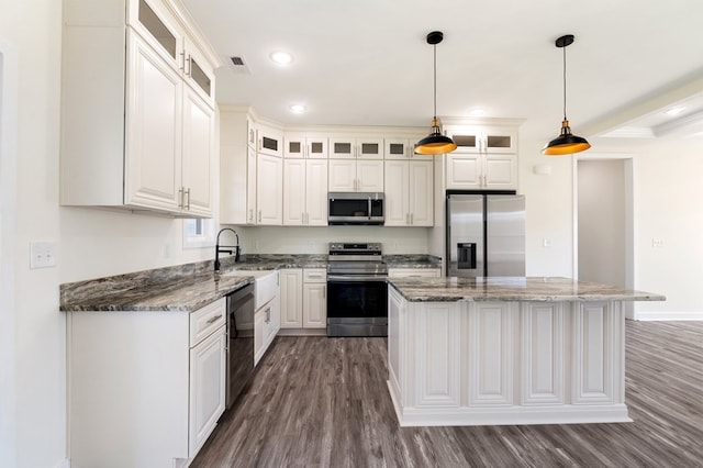 kitchen with pendant lighting, white cabinetry, a center island, and stainless steel appliances