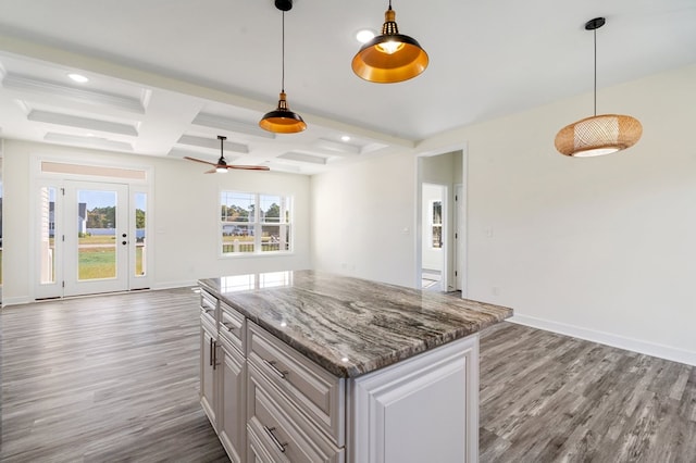 kitchen featuring coffered ceiling, ceiling fan, wood-type flooring, beamed ceiling, and hanging light fixtures