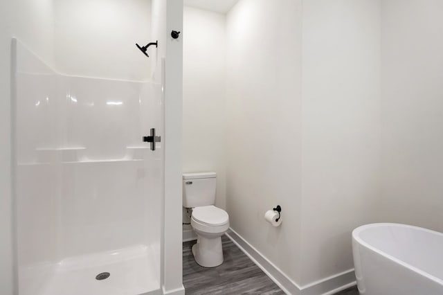 bathroom featuring toilet, wood-type flooring, and plus walk in shower