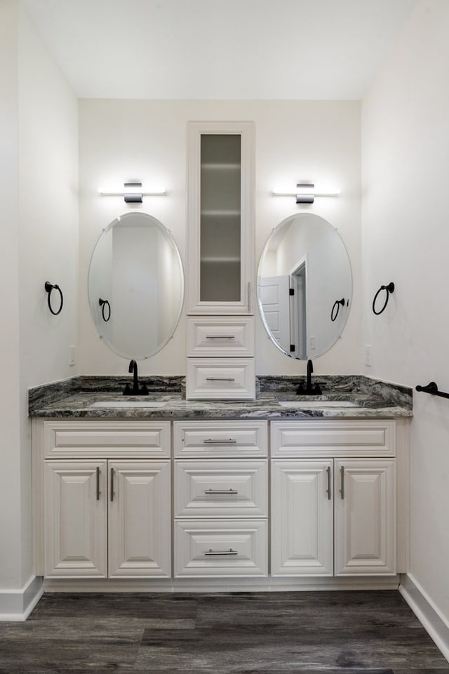 bathroom with hardwood / wood-style flooring and vanity