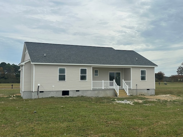 back of property with a lawn and a porch