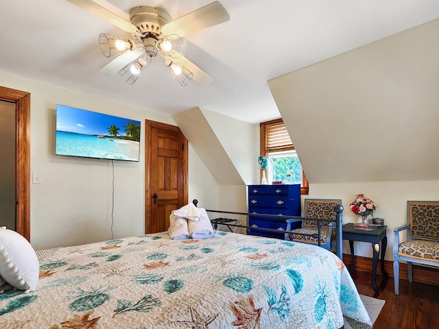 bedroom featuring dark hardwood / wood-style flooring, vaulted ceiling, and ceiling fan