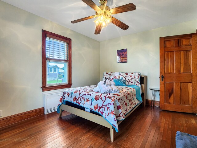 bedroom featuring ceiling fan and dark wood-type flooring