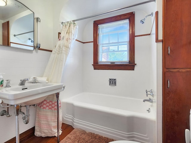 bathroom featuring wood-type flooring and shower / tub combo with curtain