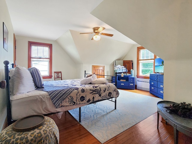 bedroom with hardwood / wood-style floors, ceiling fan, and vaulted ceiling