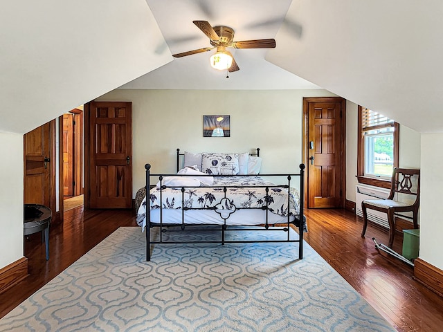 bedroom with hardwood / wood-style flooring, vaulted ceiling, and ceiling fan