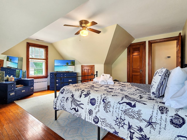 bedroom featuring ceiling fan, light hardwood / wood-style floors, and vaulted ceiling