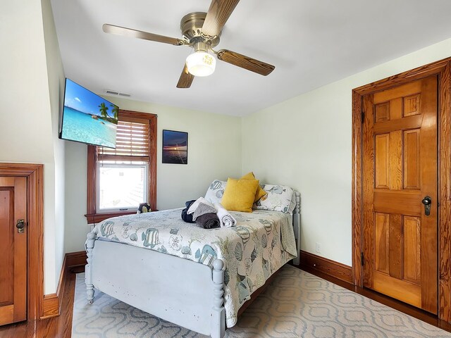 bedroom with ceiling fan and wood-type flooring