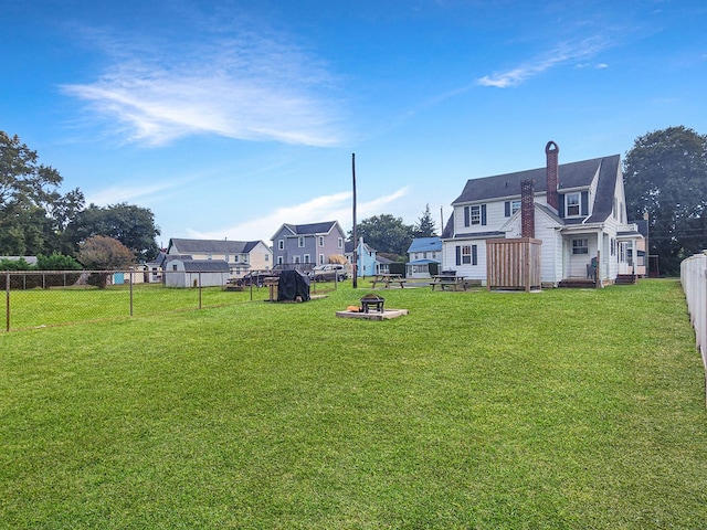 view of yard featuring an outdoor fire pit