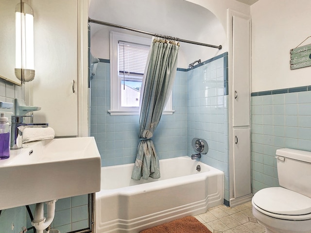 full bathroom featuring sink, tile patterned flooring, toilet, tile walls, and shower / tub combo