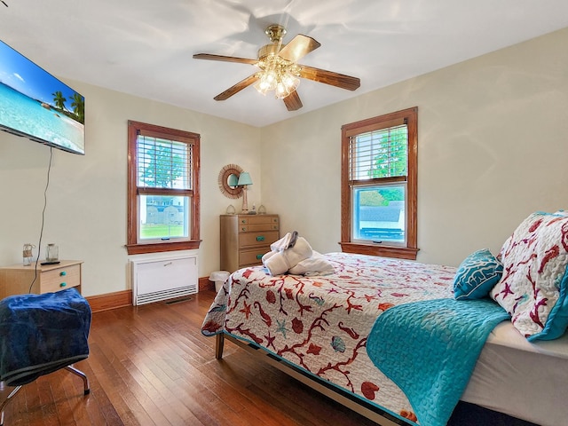 bedroom with ceiling fan and dark wood-type flooring