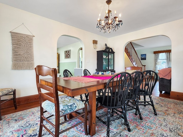 dining space with a chandelier and hardwood / wood-style flooring