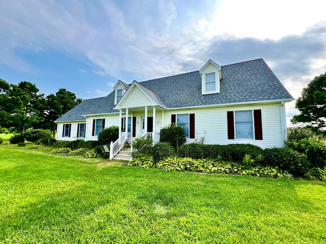 cape cod home with a front lawn