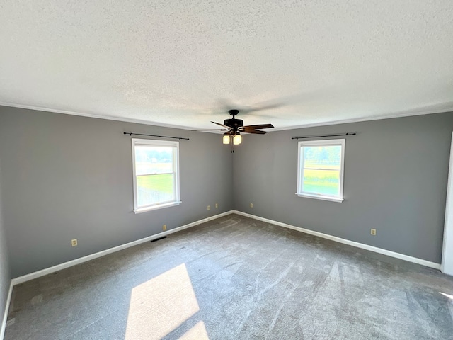 carpeted empty room with a textured ceiling and ceiling fan